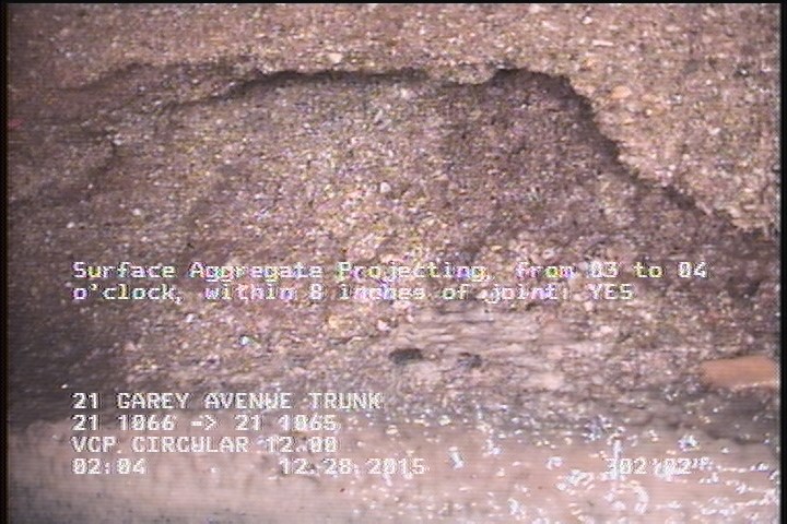 Surface Aggregate Missing, from 03 to 04 o'clock, within 8 inches of joint: YES - AT THE CHANNEL INSIDE MH 1065