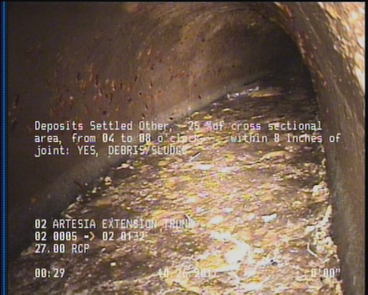 Deposits Settled Other, 25 %of cross sectional area, from 04 to 08 o'clock, , within 8 inches of joint: YES - DEBRIS/SLUDGE