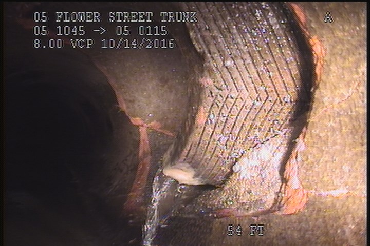 Tap Break-In Intruding, at 02 o'clock, -, -, within 8 inches of joint: YES, 6", 2"INTRUDING - Active
