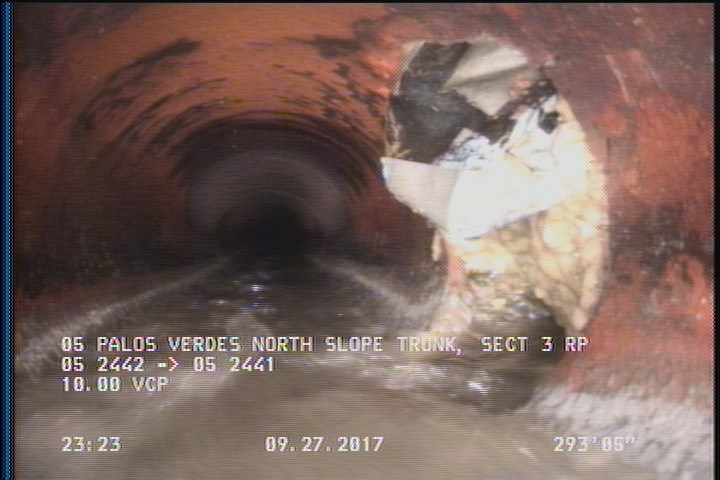 Tap Break-In, at 04 o'clock, -, within 8 inches of joint: YES, 6" - UNABLE TO SEE IF ITS ACTIVE, 100% BLOCKED, POSSIBLE CAPPED LATERAL