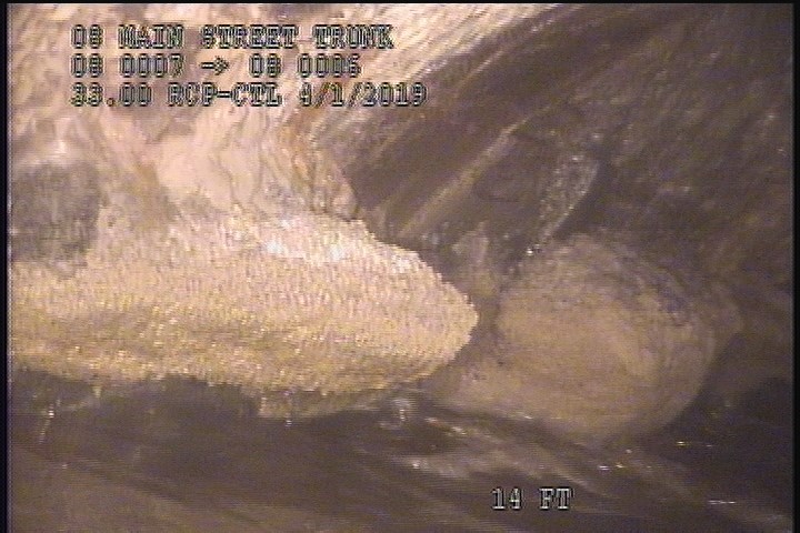 Deposits Attached Grease, 10 %of cross sectional area, from 08 to 09 o'clock, , within 8 inches of joint: NO - INSIDE MH