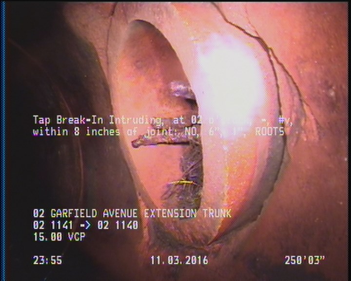 Tap Break-In Intruding, at 02 o'clock, -, #v, within 8 inches of joint: NO, 6", 1" - ROOTS