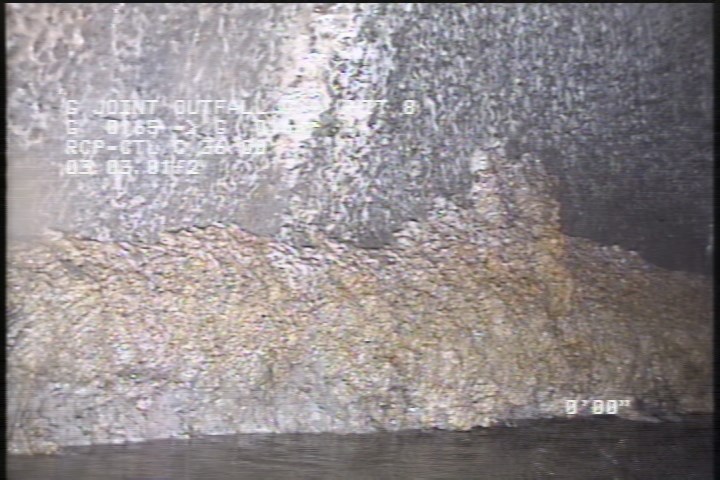 Deposits Attached Grease, 15 %of cross sectional area, from 07 to 09 o'clock, , within 8 inches of joint: NO - INSIDE MH