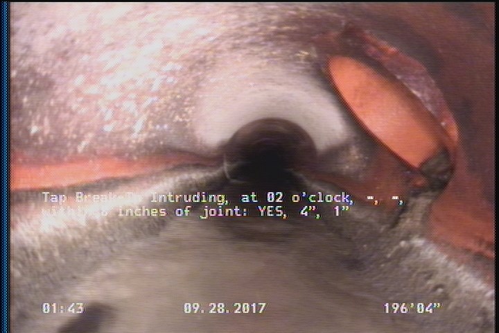 Tap Break-In Intruding, at 02 o'clock, -, -, within 8 inches of joint: YES, 4", 1"