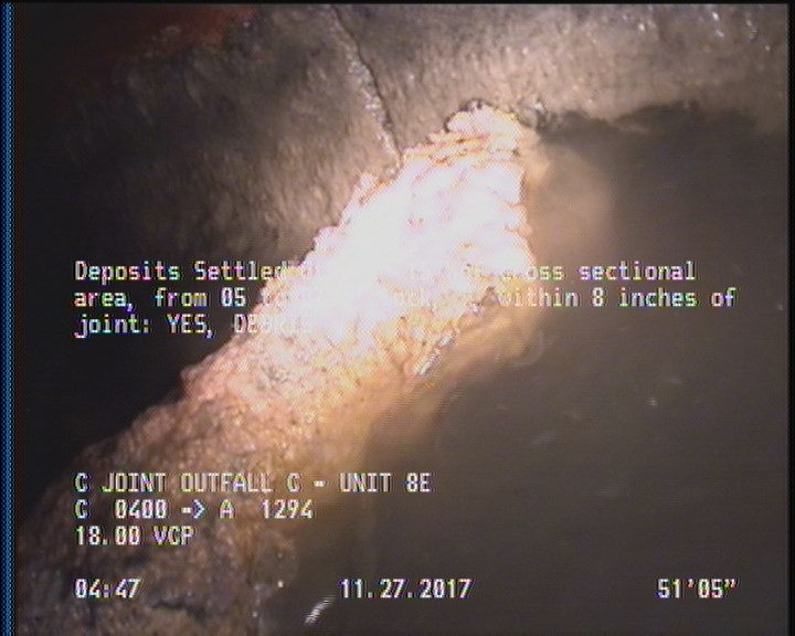 Deposits Settled Other, 15 %of cross sectional area, from 05 to 07 o'clock, , within 8 inches of joint: YES - DEBRIS