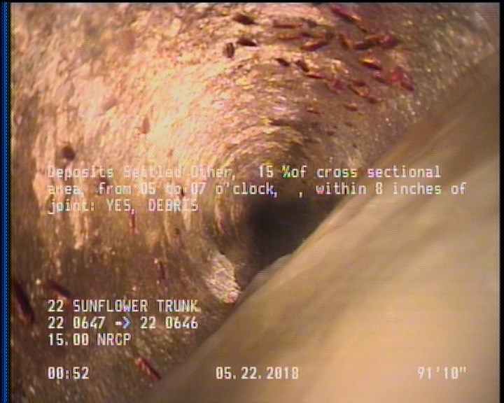 Deposits Settled Other, 15 %of cross sectional area, from 05 to 07 o'clock, , within 8 inches of joint: YES - DEBRIS