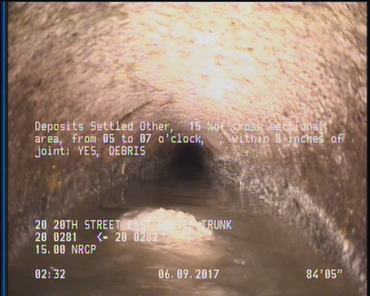 Deposits Settled Other, 15 %of cross sectional area, from 05 to 07 o'clock, , within 8 inches of joint: YES - DEBRIS