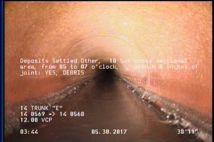 Deposits Settled Other, 15 %of cross sectional area, from 05 to 07 o'clock, , within 8 inches of joint: YES - DEBRIS