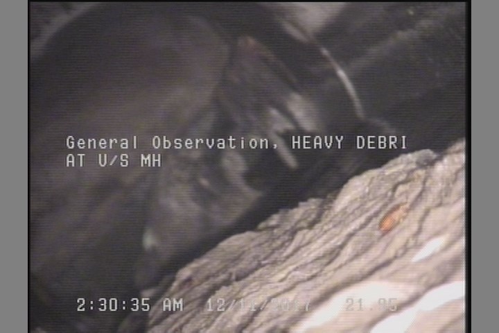 General Observation - HEAVY DEBRIS AT U/S MH, STICK BLOCKING FROM 01 TO 06 O'CLOCK-SOFFIT