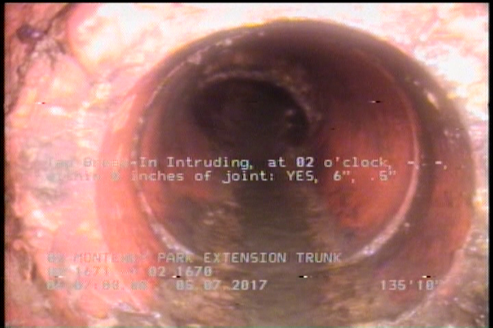 Tap Break-In Intruding, at 02 o'clock, -, -, within 8 inches of joint: YES, 6", .5"