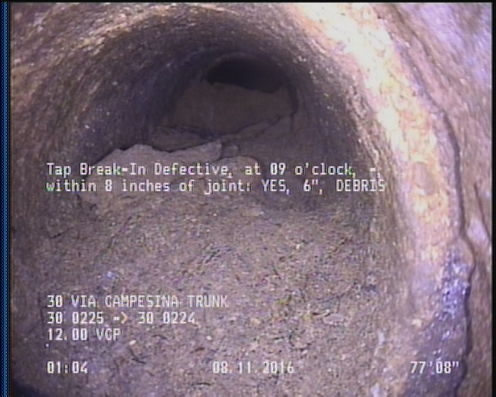 Tap Break-In Defective, at 09 o'clock, -, , within 8 inches of joint: YES, 6" - DEBRIS
