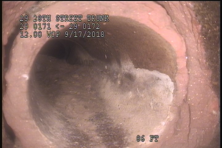 Tap Break-In Defective, at 09 o'clock, -, , within 8 inches of joint: YES, 4" - Open/30% GREASE-LATERAL
