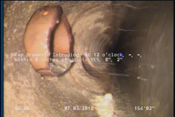 Tap Break-In Intruding, at 12 o'clock, -, -, within 8 inches of joint: YES, 8", 2"