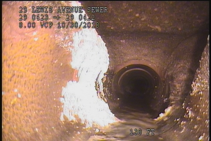 Deposits Attached Grease, 5 %of cross sectional area, from 07 to 10 o'clock, , within 8 inches of joint: NO - INSIDE MH